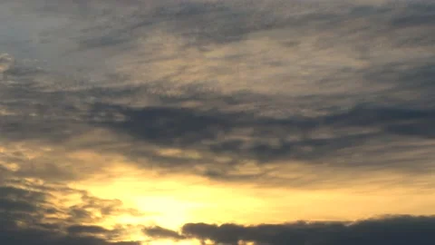 Cloudy sky and golden sun behind clouds at sunrise - sky background - Time Lapse Stock Footage 144303474