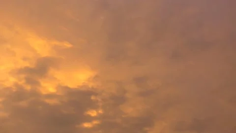 Cloudy sky and golden sun behind clouds at sunrise - sky background - Time Lapse Stock Footage 144318283