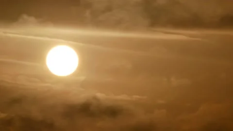 Cloudy sky and golden sun behind clouds at sunrise - sky background - Time Lapse Stock Footage 152560342