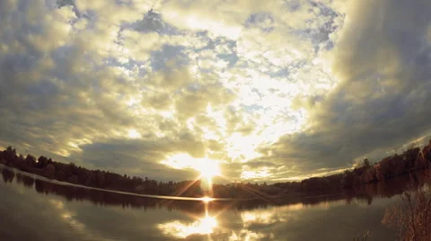 Cloudy sky and pond, which reflects the sunset of the evening sun Video stock 61564707
