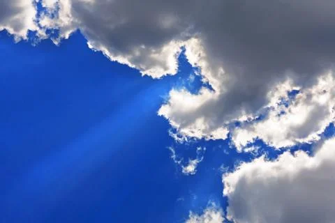 Cloudy sky and sun rays Stock Photos