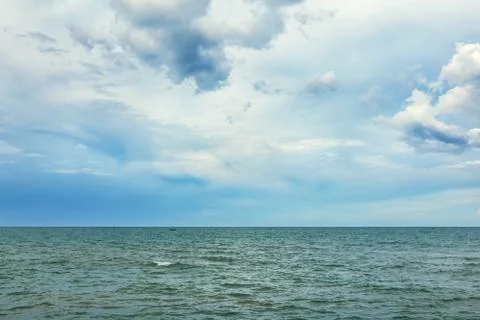 Cloudy sky and surface of sea in the cloudy day Stock Photos