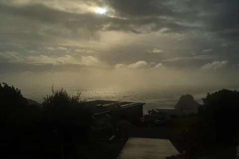 Cloudy sky and wavy ocean in New Zealand, Piha Beach, winter time Stock Photos