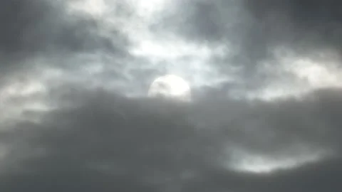 Cloudy sky and white sun behind clouds at sunrise - sky background - Real Time Stock Footage 150009103