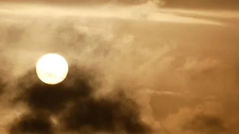 Cloudy sky and white sun behind clouds at sunrise - sky background - Real Time Stock Footage 152562193
