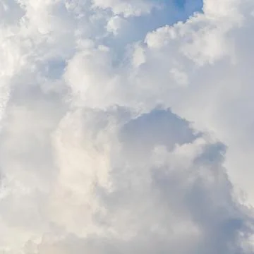 Cloudy sky background. Sunlight shining through white clouds. Stock Photos