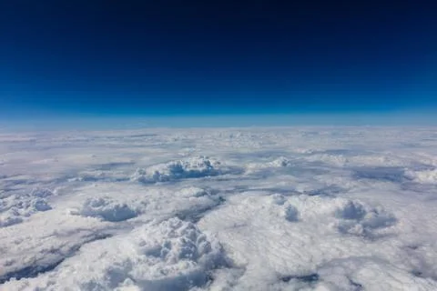 Cloudy sky background. View out of an airplane window. Stock Photos