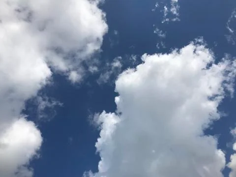 Cloudy sky on a bright day Stock Photos