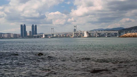 Cloudy sky at Busan Gwangalli Beach and Gwangan Bridge. 動画素材 140615068