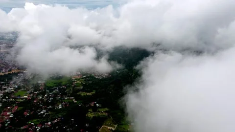 A cloudy sky with a city in the background. Aerial view Bukit Mertajam Видео 325790601