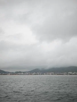 A cloudy sky with a city in the background Stock Photos