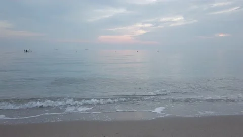 Cloudy sky, dark clouds. Evening. Sunset. sandy beach. Sea waves with white foam Stock Footage 143853899