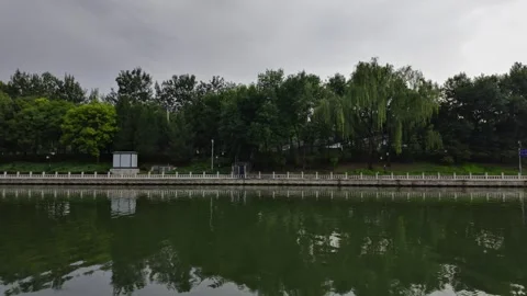 Cloudy Sky, Dark Clouds, Trees and River Water Stock Footage 316517803