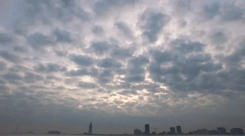Cloudy sky down to skyline across the river, grass in foreground at end Baton Stock Footage 53368714