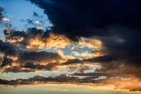 Cloudy sky during sunset in blue and yellow Stock Photos