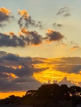 A cloudy sky at the end of the day with various shades of light, particularly Stock Photos