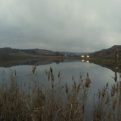 Cloudy sky, evening lake, highway Stock Footage 69619364