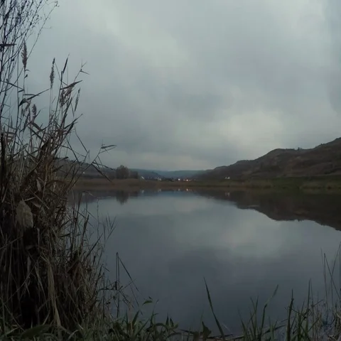 Cloudy sky, evening lake, highway Stock Footage 69619400