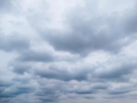 A cloudy sky filled with gray clouds creating a moody atmosphere, suitable for Stock Photos