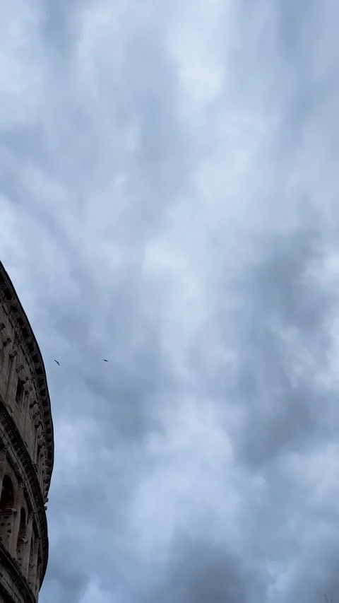 The cloudy sky intertwines with the mesmerizing architecture of the Colosseum Stock Footage 301378219