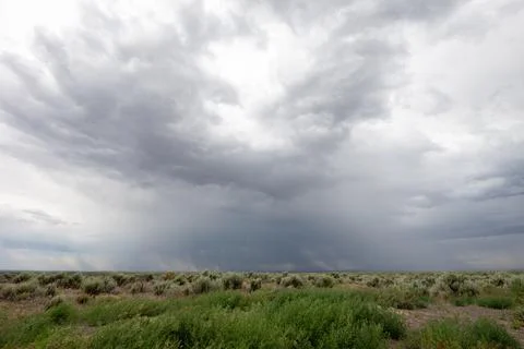 A cloudy sky with a large storm cloud in the middle 스톡 사진