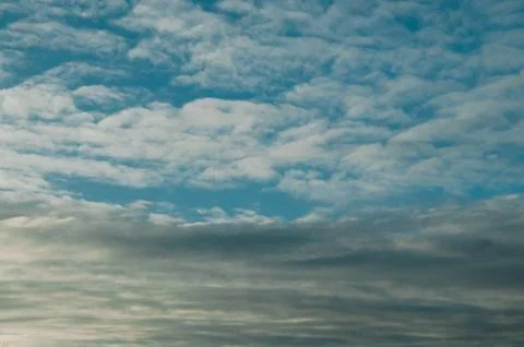 Cloudy Sky with Layered White and Gray Clouds Stock Photos