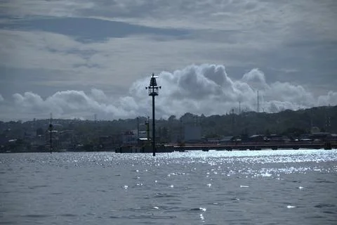 A cloudy sky with a lighthouse in the distance Stock Photos