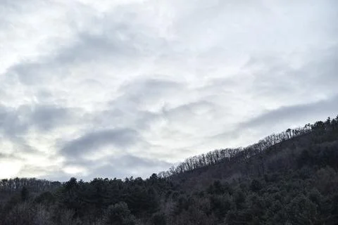 A cloudy sky with a mountain in the background Stock Photos