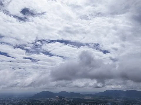 A cloudy sky with a mountain in the background Stock Photos