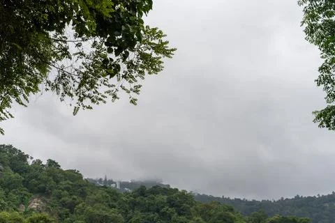 A cloudy sky with a mountain in the background 스톡 사진