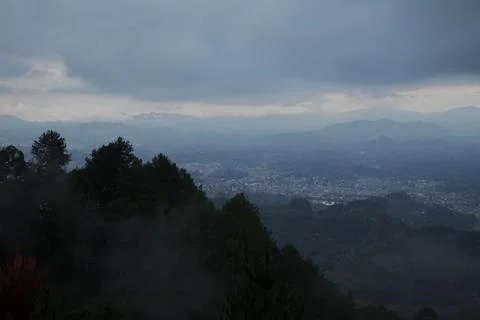 A cloudy sky with a mountain range in the background Stock Photos