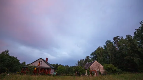 Cloudy sky over buildings in forest. 4k timelapse Stock Footage 313197070