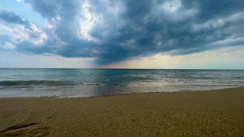 Cloudy sky over calm sea and beach, blue color grading Stock Footage 278847541