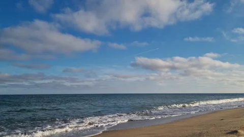 Cloudy sky over calm sea horizon with gentle ocean waves Stock Footage 321199141