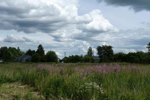 Cloudy sky over the field Stock Photos