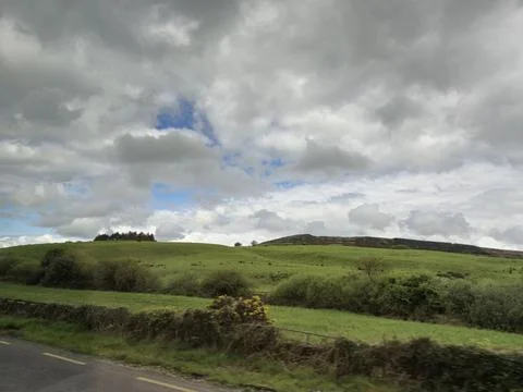 Cloudy Sky Over Grass and Asphalt Road Фото