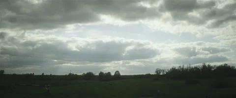 Cloudy sky over green valley cinemascope Stock Footage 242800950