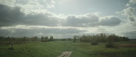 Cloudy sky over green valley cinemascope Stock Footage 242862165