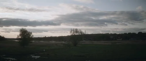 Cloudy sky over green valley in the evening Stock Footage 242862889