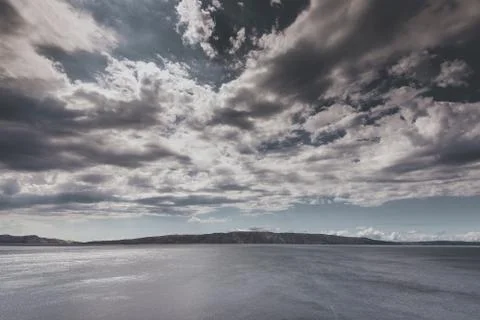 Cloudy sky over the island Stock Photos