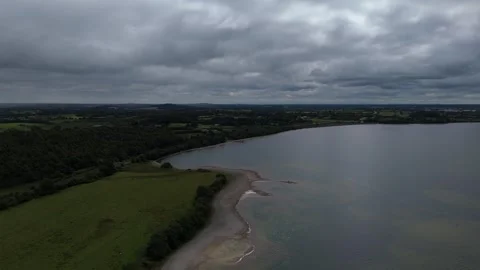 A cloudy sky over a lake and grass Stock Footage 328523020