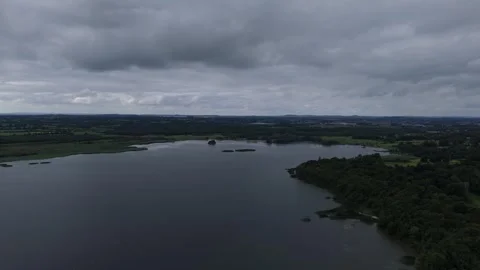 A cloudy sky over a lake and trees Stock Footage 328536380