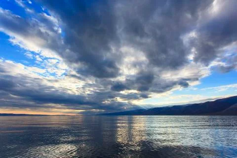 Cloudy sky over the lake Stock Photos