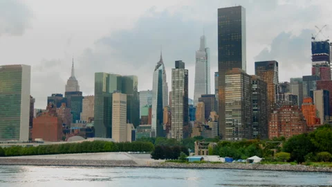 Cloudy Sky Over Manhattan Skyline with Greenery Foreground Stock Footage 266159393