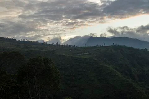 Cloudy sky over Mount Sindoro. black clouds with morning sunlight Stock Photos