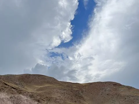 Cloudy sky over mountain peaks Stock Photos