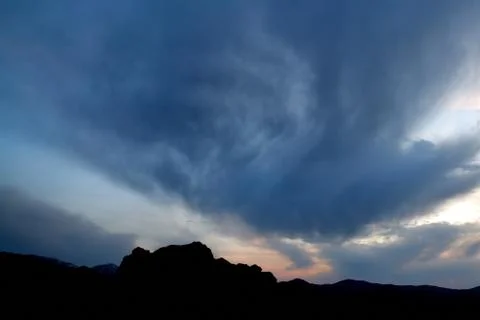 Cloudy sky over the mountain Stock Photos
