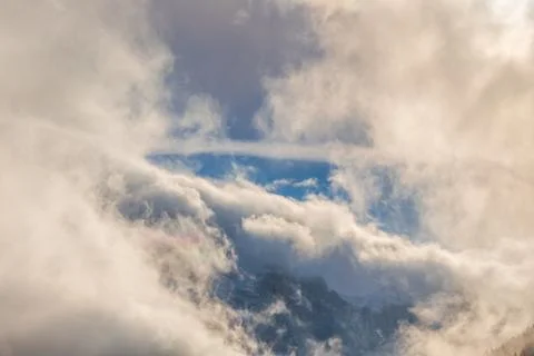 Cloudy sky over mountains Stock Photos