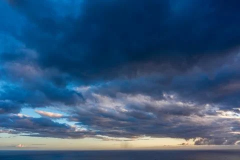 A cloudy sky over the ocean at sunset Stock Photos
