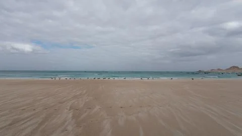 Cloudy sky over a quiet sandy beach Stock Photos